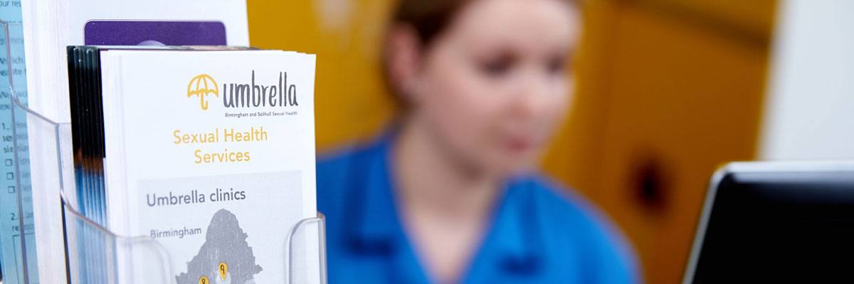 Umbrella Sexual Health leaflets and member of staff
