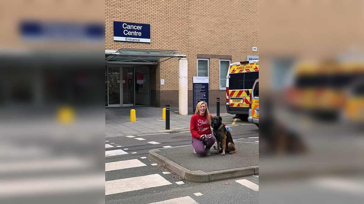 Joanna Long, former breast cancer patient, outside the Cancer Centre at Queen Elizabeth Hospital Birmingham on her last day of radiotherapy treatment with her dog Bosco