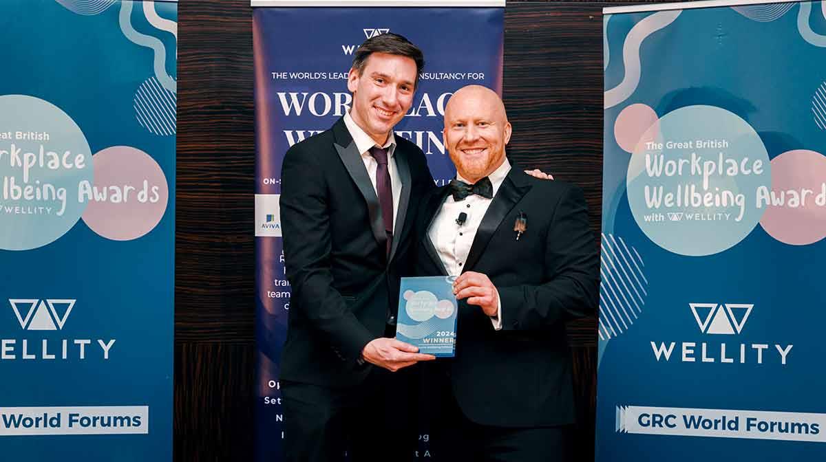 Jeff Bryan (left), accepting the award on behalf of the team at the ceremony.
